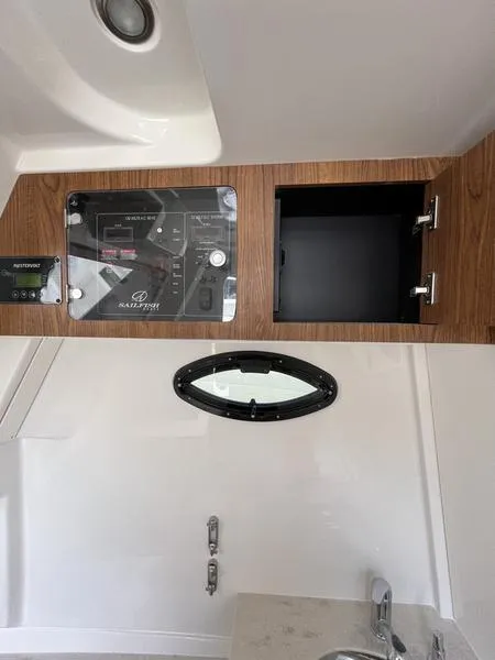 Slide: The Image of Control panel and storage area inside 2024 Sailfish 360 CC boat. - 48
