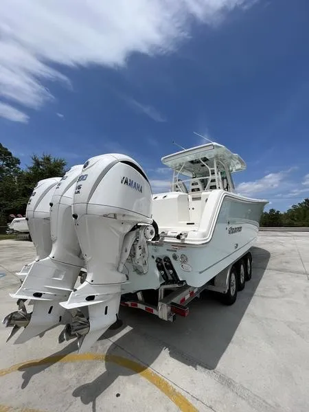 Slide: The Image of 2024 Sailfish 360 CC boat with twin Yamaha engines on a trailer. - 53