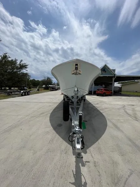 Slide: The Image of 2024 Sailfish 360 CC boat on a trailer, front view, outdoor setting. - 54