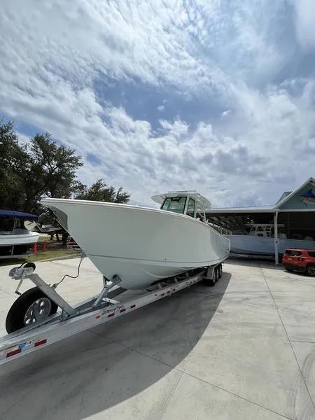 Slide: The Image of 2024 Sailfish 360 CC boat on trailer under cloudy sky. - 55