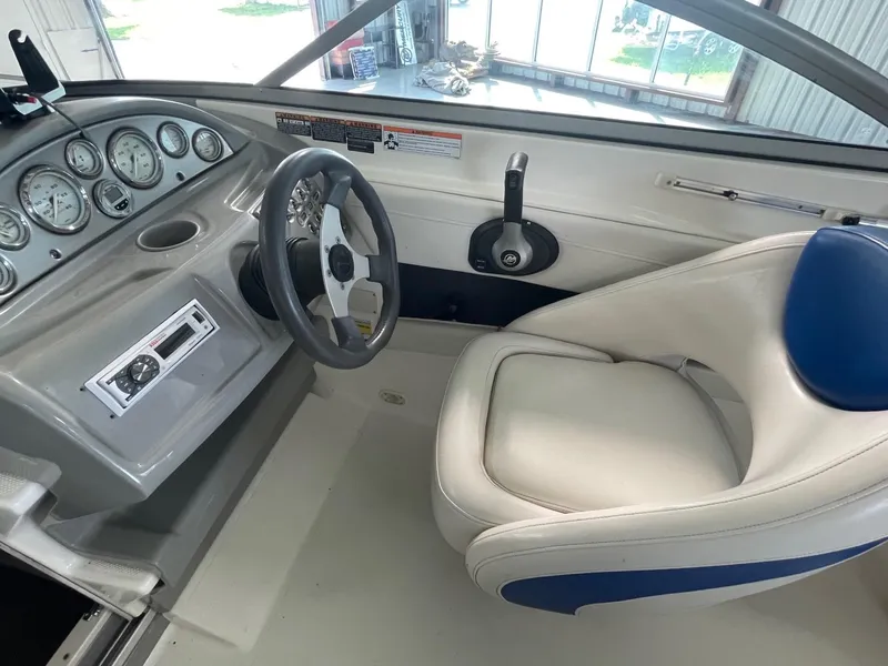 Slide: The Image of 2007 Bayliner 212 boat cockpit with steering wheel, gauges, and captain's chair. - 6
