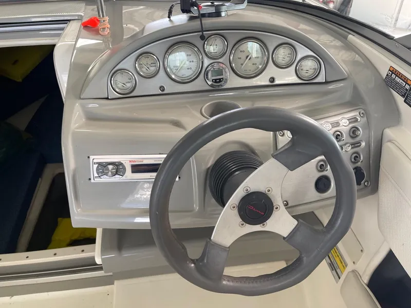 Slide: The Image of 2007 Bayliner 212 boat dashboard with steering wheel and instrument panel. - 9