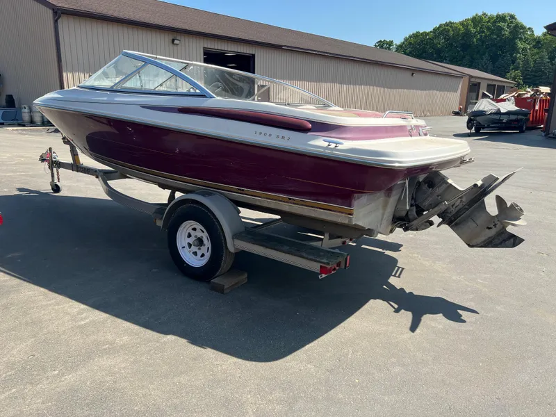 Slide: The Image of 1996 Maxum 1900 SR2 boat on trailer in outdoor storage area. - 3