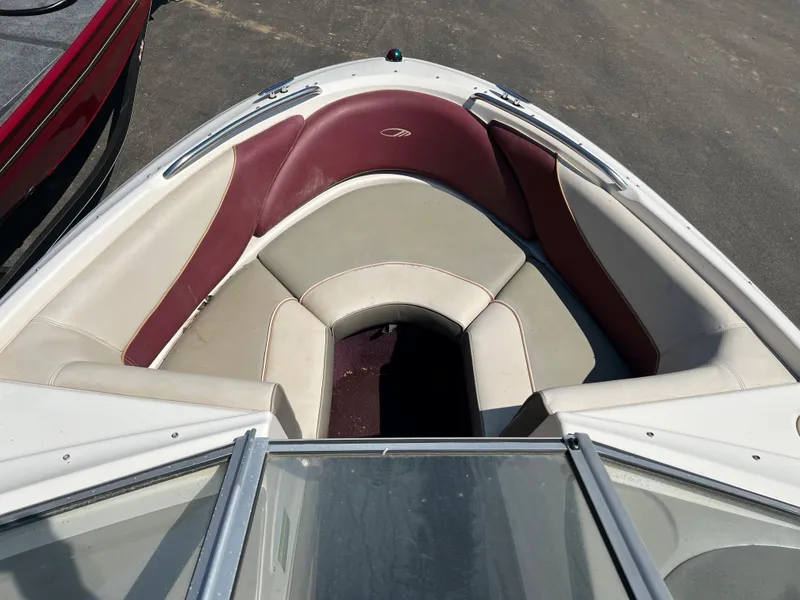 Slide: The Image of 1996 Maxum 1900 SR2 boat bow seating area with maroon and beige upholstery. - 6