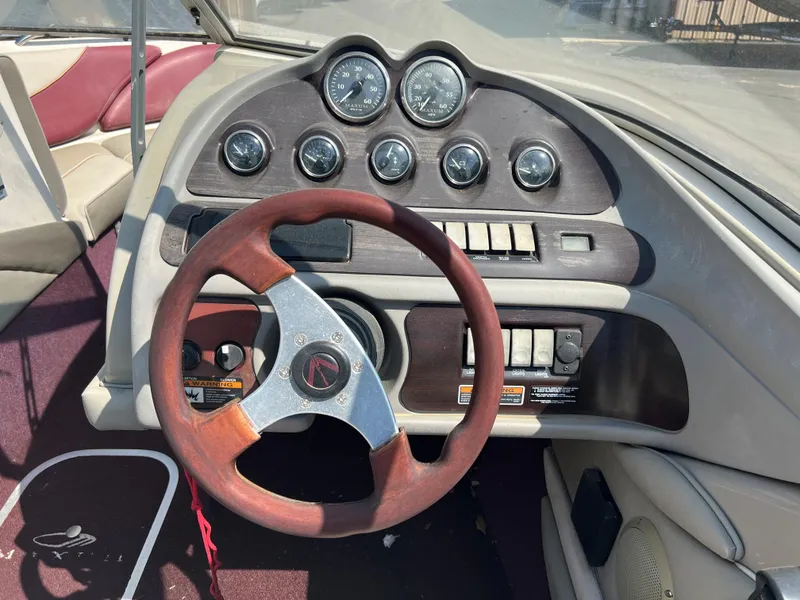 Slide: The Image of 1996 Maxum 1900 SR2 boat dashboard with gauges and steering wheel. - 7