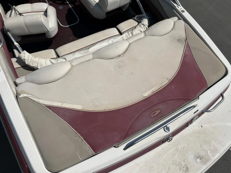 Slide: The Image of 1996 Maxum 1900 SR2 boat interior with worn upholstery. - 8