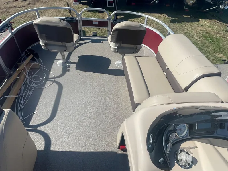 Slide: The Image of 2018 Sun Tracker Fishin' Barge 20 DLX interior with seating and control panel. - 14