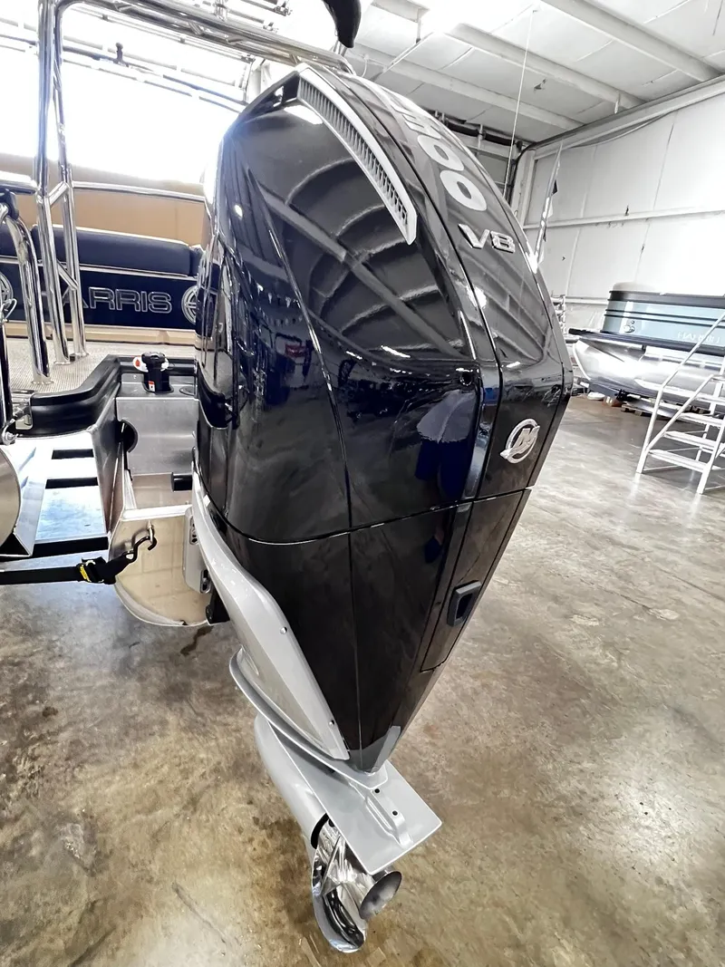 Slide: The Image of 2024 Harris Grand Mariner 230 with powerful V8 outboard engine in a showroom. - 11