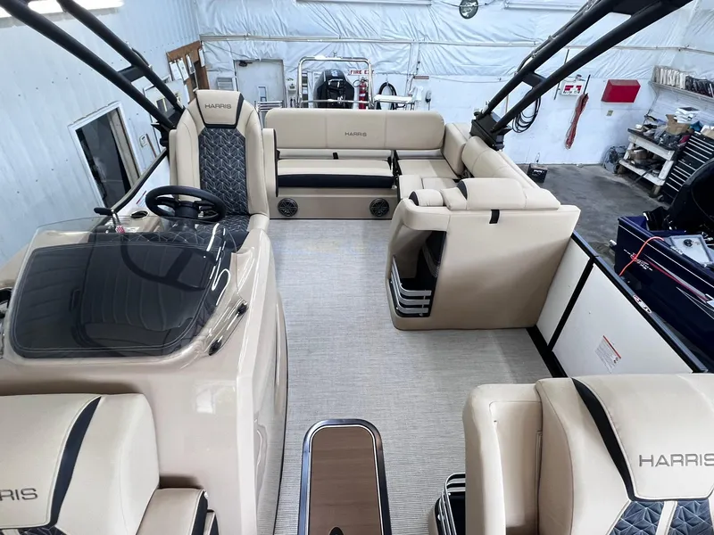 Slide: The Image of 2024 Harris Grand Mariner 230 boat interior with beige seating and modern helm. - 18