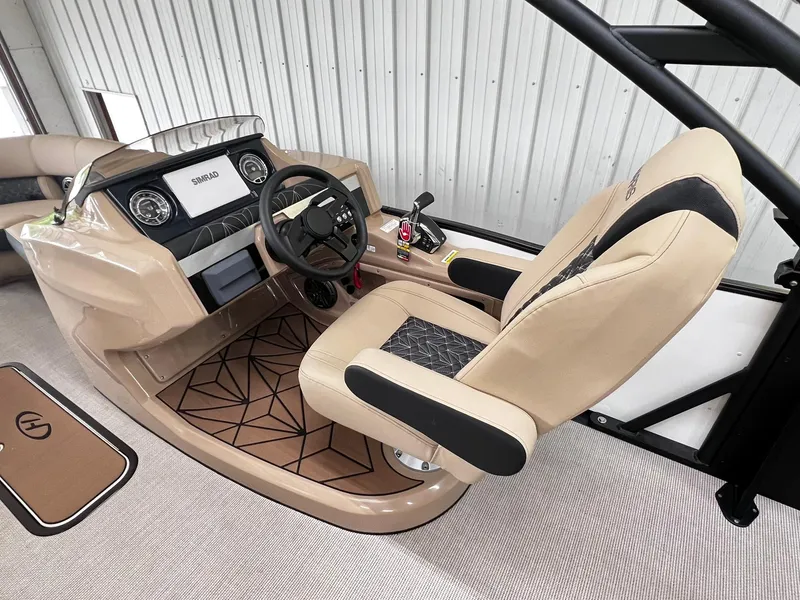 Slide: The Image of 2024 Harris Grand Mariner 230 boat helm with beige captain's chair and modern dashboard. - 19