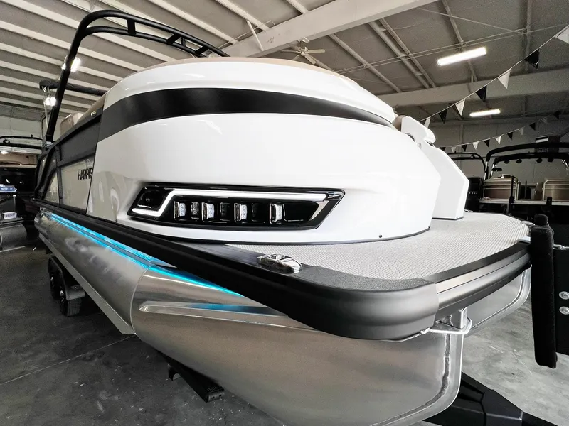Slide: The Image of 2024 Harris Grand Mariner 230 pontoon boat in showroom. - 2