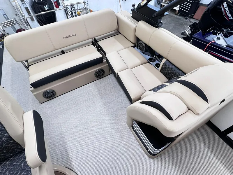 Slide: The Image of 2024 Harris Grand Mariner 230 boat interior with beige seating and built-in speakers. - 20