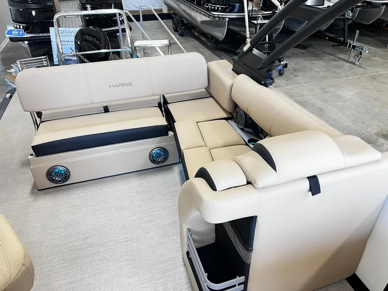 Slide: The Image of 2024 Harris Grand Mariner 230 pontoon boat interior with beige seating and built-in speakers. - 21