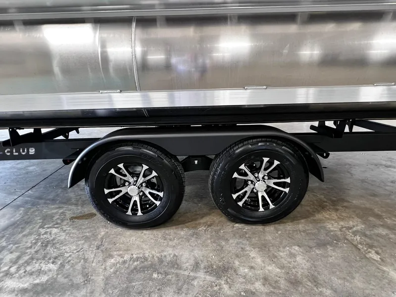 Slide: The Image of 2024 Harris Grand Mariner 230 trailer with dual black alloy wheels. - 31