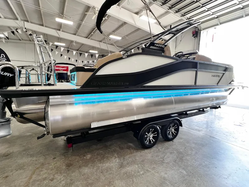 Slide: The Image of 2024 Harris Grand Mariner 230 pontoon boat on a trailer in a showroom. - 4