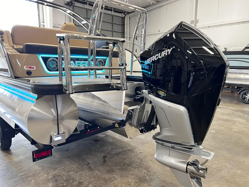 Slide: The Image of 2024 Harris Grand Mariner 230 pontoon boat with Mercury outboard motor in a showroom. - 5