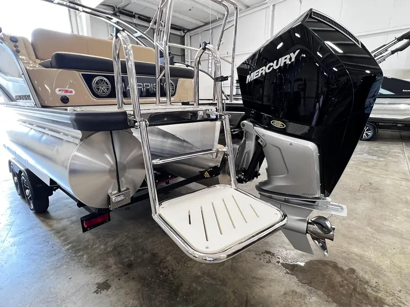 Slide: The Image of 2024 Harris Grand Mariner 230 pontoon boat with Mercury outboard motor in a showroom. - 6