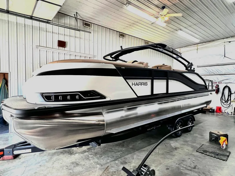 Slide: The Image of 2024 Harris Grand Mariner 230 pontoon boat in a storage facility. - 7