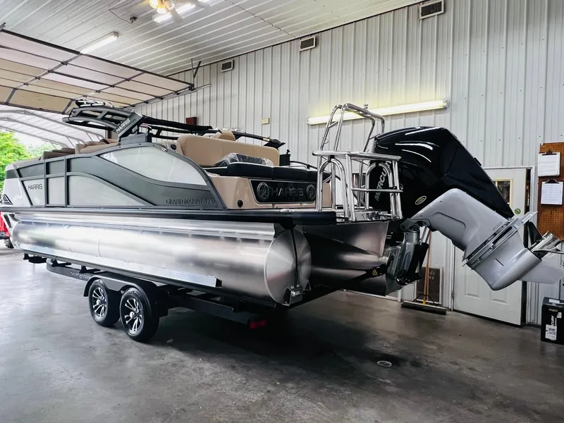 Slide: The Image of 2024 Harris Grand Mariner 230 pontoon boat in a garage. - 8