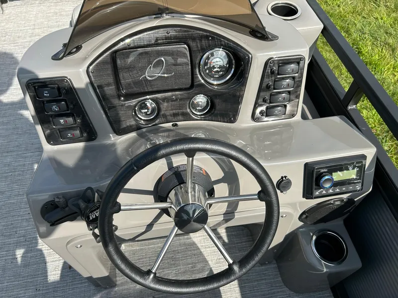 Slide: The Image of 2023 Qwest 820 RLS L boat dashboard with steering wheel and control panel. - 12