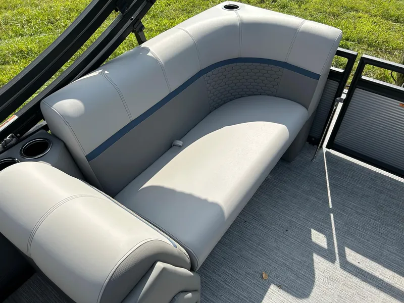 Slide: The Image of 2023 Qwest 820 RLS L boat interior with gray seating and cup holders. - 13