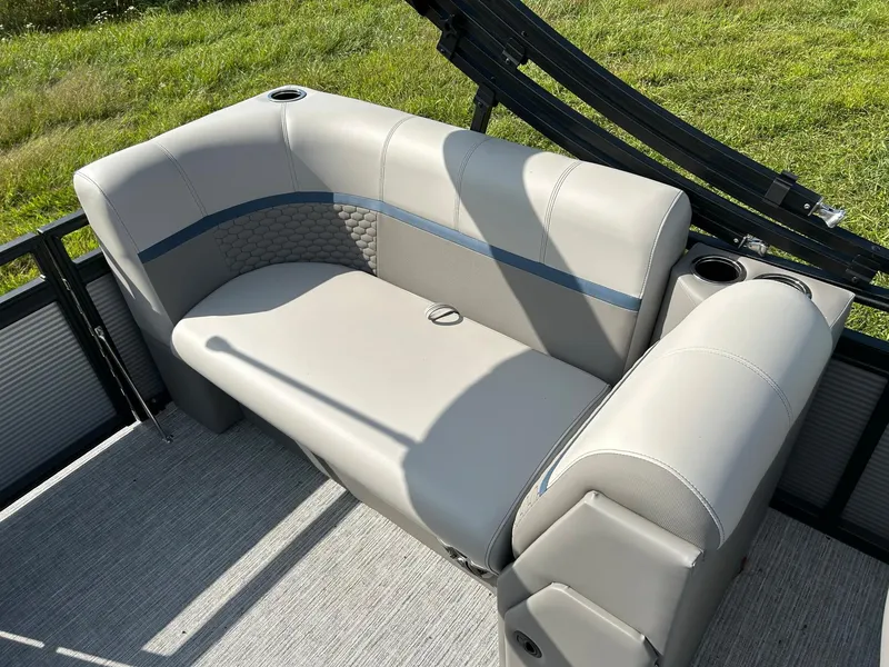 Slide: The Image of 2023 Qwest 820 RLS L boat interior seating with cup holders. - 14