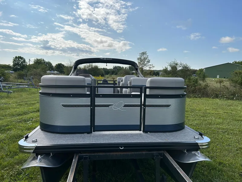 Slide: The Image of 2023 Qwest 820 RLS L pontoon boat on grassy field under blue sky. - 2
