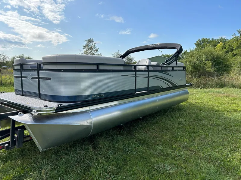 Slide: The Image of 2023 Qwest 820 RLS L pontoon boat on grassy field under blue sky. - 3