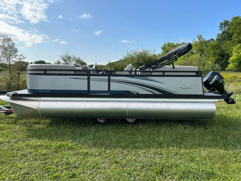 Slide: The Image of 2023 Qwest 820 RLS L pontoon boat on grass with trees in the background. - 4