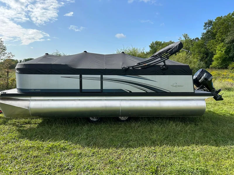 Slide: The Image of 2023 Qwest 820 RLS L pontoon boat with cover on grassy field. - 5
