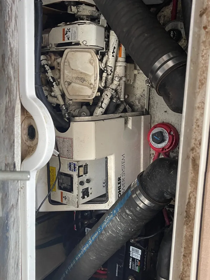 Slide: The Image of 1997 Cruisers Yachts 3375 Esprit engine compartment with generator and hoses. - 17
