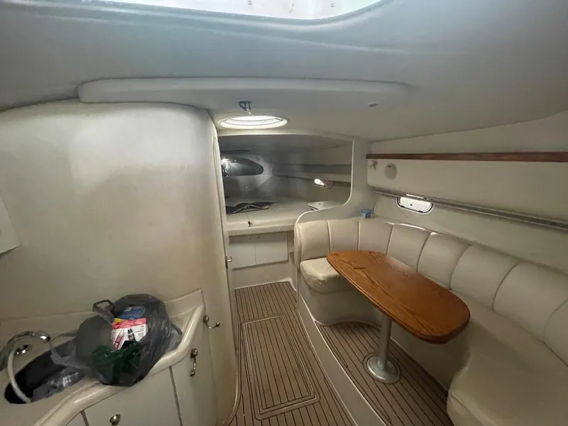 Slide: The Image of 1997 Cruisers Yachts 3375 Esprit cabin interior with seating and table. - 8