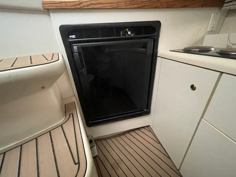 Slide: The Image of 1997 Cruisers Yachts 3375 Esprit interior with compact refrigerator and kitchenette. - 12