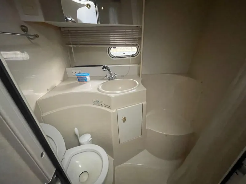 Slide: The Image of 1997 Cruisers Yachts 3375 Esprit bathroom with sink, toilet, and shower. - 13