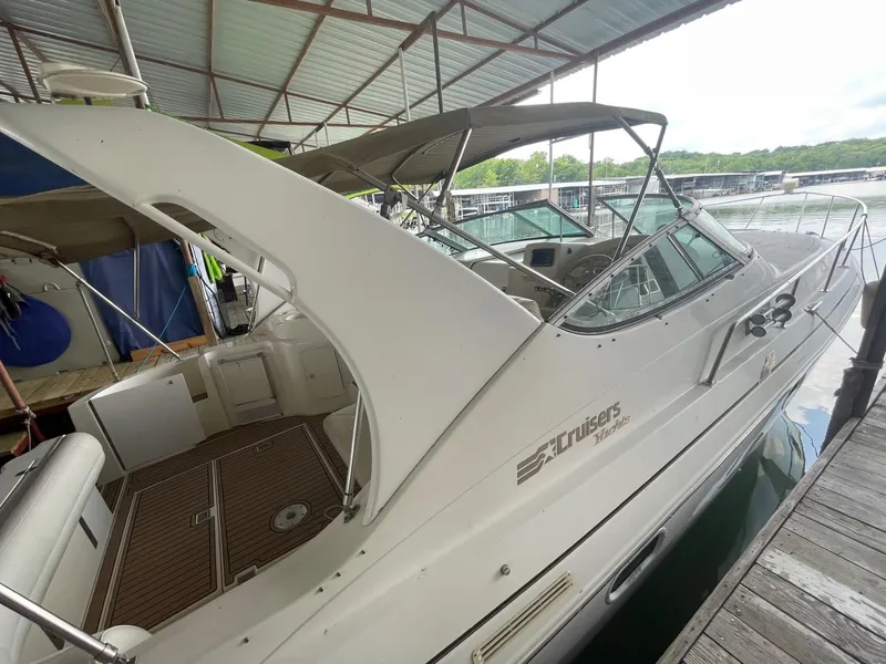 Slide: The Image of 1997 Cruisers Yachts 3375 Esprit docked under a covered marina. - 2