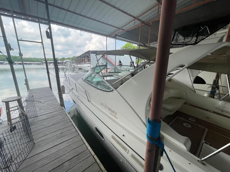 Slide: The Image of 1997 Cruisers Yachts 3375 Esprit docked under a covered marina. - 3