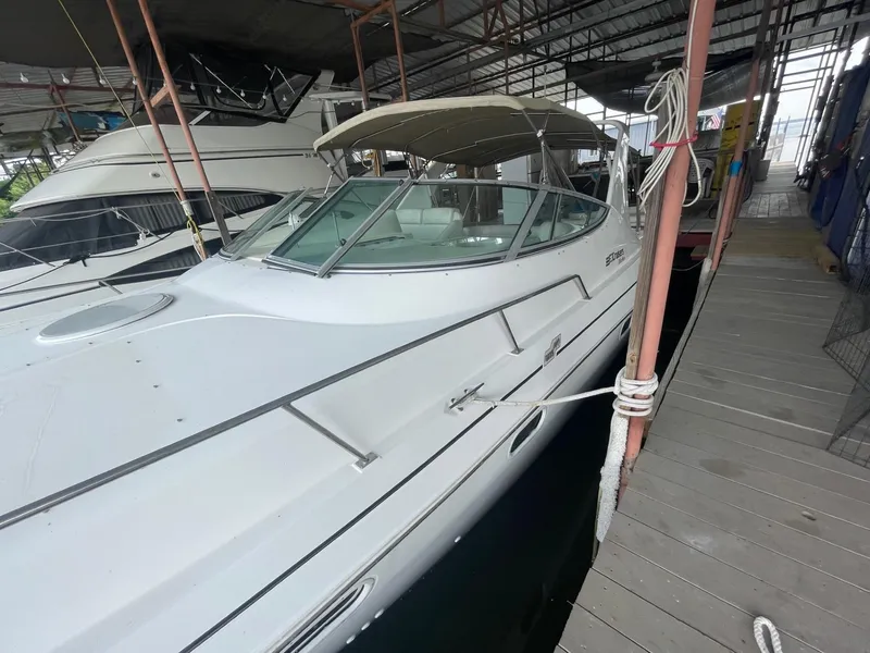 Slide: The Image of 1997 Cruisers Yachts 3375 Esprit docked in a marina under a covered slip. - 4