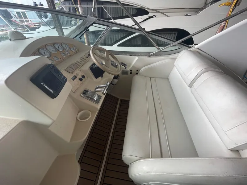 Slide: The Image of 1997 Cruisers Yachts 3375 Esprit cockpit with white seating and control panel. - 7