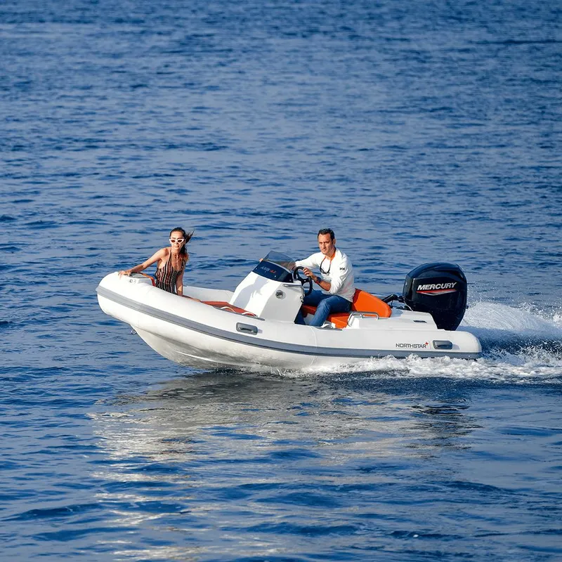 Slide: The Image of 2022 Northstar Axis 4.2 boat cruising on open water with two passengers. - 11