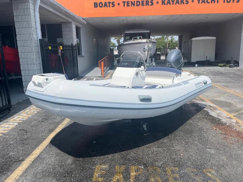 Slide: The Image of 2022 Northstar Axis 4.2 inflatable boat displayed at a marine dealership. - 2