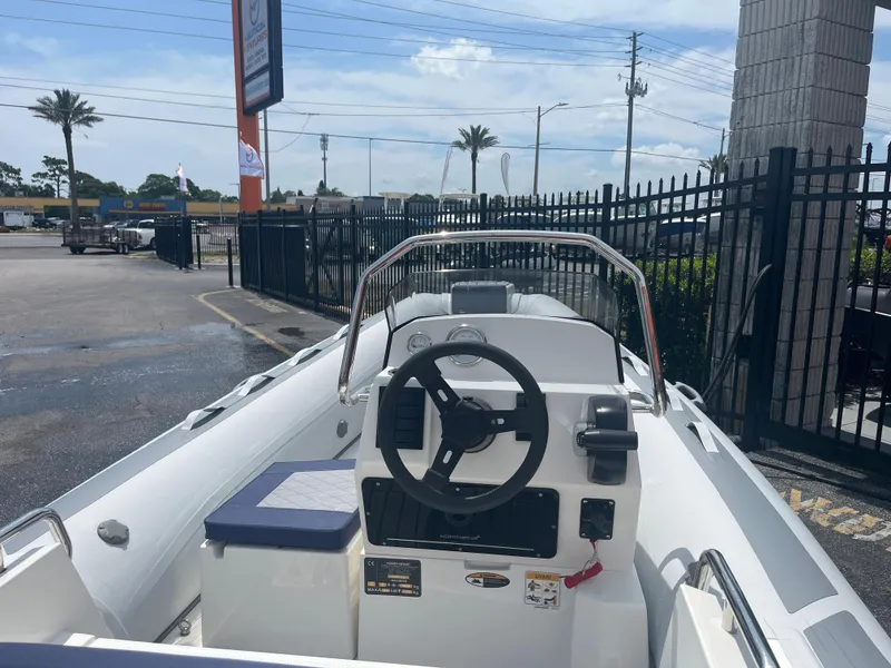 Slide: The Image of 2022 Northstar Axis 4.2 boat, white interior, steering wheel, outdoor display. - 6