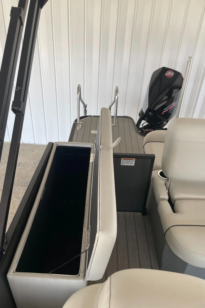 Slide: The Image of 2023 Sylvan Mirage X X5 CLZ boat interior with storage compartment and seating. - 12