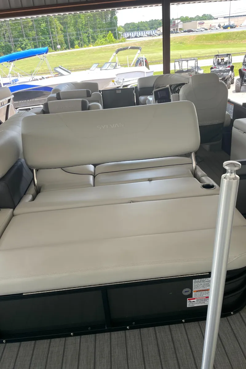Slide: The Image of 2023 Sylvan Mirage X X5 CLZ pontoon boat with beige seating at a marina. - 14