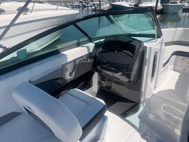 Slide: The Image of 2017 Monterey 258 SS boat interior with helm and seating area. - 1