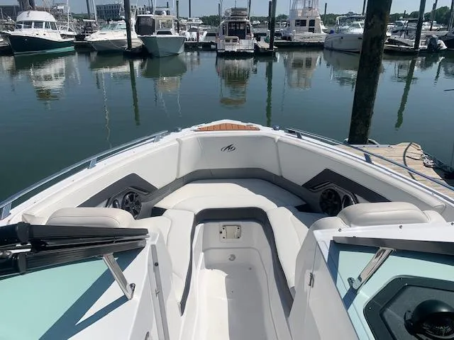 Slide: The Image of 2017 Monterey 258 SS boat docked at a marina with other boats. - 10