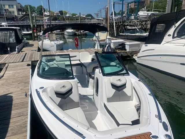 Slide: The Image of 2017 Monterey 258 SS boat docked at a marina, featuring sleek white seating and modern design. - 11