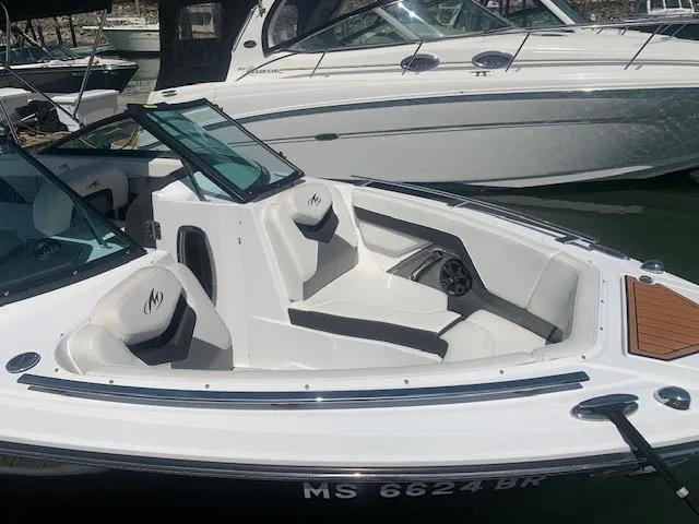 Slide: The Image of 2017 Monterey 258 SS boat docked, featuring white and black seating. - 12