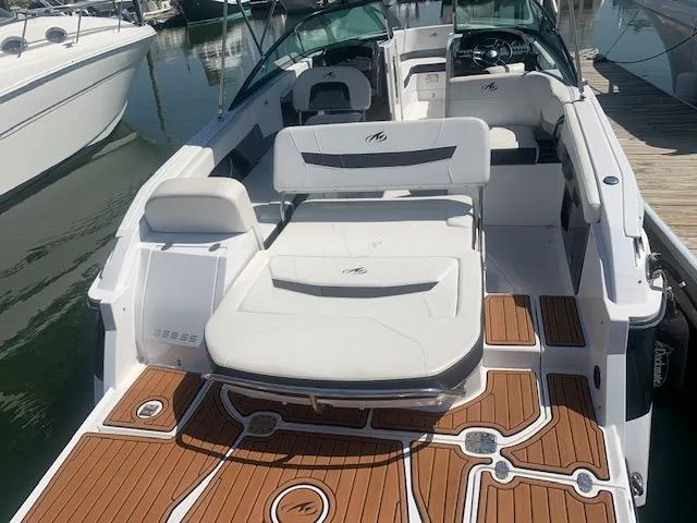 Slide: The Image of 2017 Monterey 258 SS boat with white seating and teak-style flooring at a marina. - 5