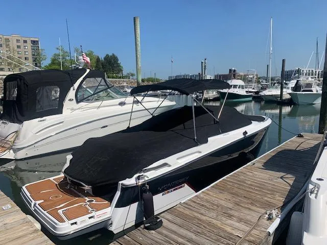 Slide: The Image of 2017 Monterey 258 SS boat docked at a marina with a black cover. - 9