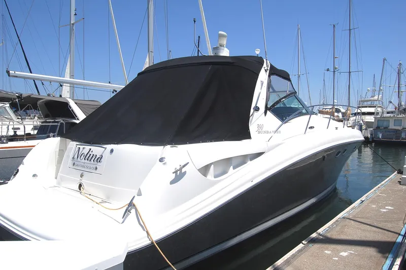 Slide: The Image of 2005 Sea Ray 390 Sundancer docked at marina, covered with black canvas. - 17